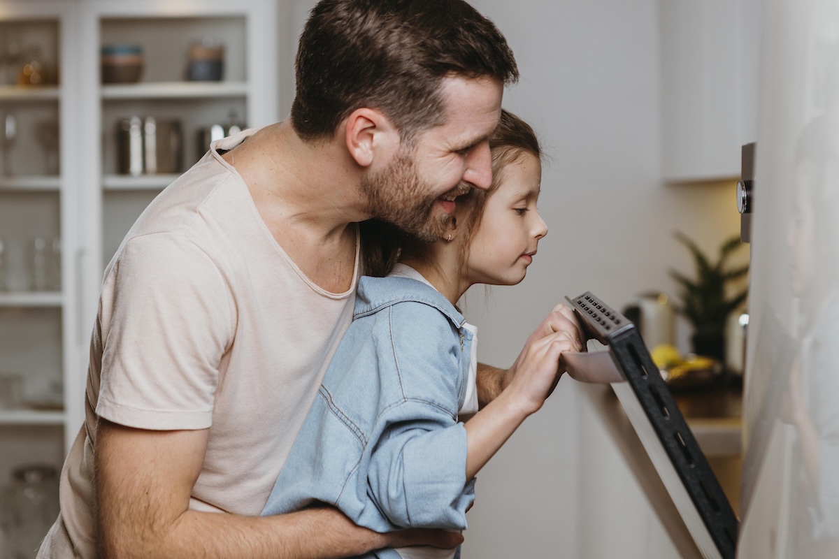 Father and daughter baking cookies together.